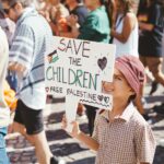 kid with a banner on a free palestine march