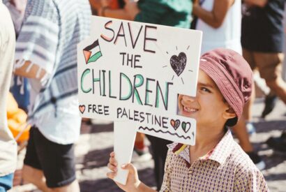 kid with a banner on a free palestine march