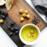 photo of ceramic bowl on top of wooden chopping board